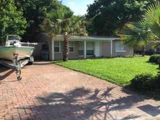 W-O-W! Gorgeous updated home in a desirable neighborhood (Elliott Pt) just 1 blk from the Bay. Completely renovated from top to bottom. NEW-NEW-NEW: sod ('15), roof ('12), HVAC ('09) & more. Covered ft porch. Open living/dining/kitchen combo great for entertaining. Gorgeous travertine tile throughout & wood flooring in the bedrooms. Extra living area. Beautiful kitchen w/ granite countertops, center island, espresso soft close cabinets, stainless steel appliances, etc. Master has a lg walk in closet. All copper wiring. Nice back deck to relax on. Lg privacy fenced bkyard w/ a sprinkler system on a timer w/ a well for easy lawn care. Decorative brick pavers for a driveway w/ extra parking & double gate for a boat. Call to see today & make this your home sweet home before someone else does!