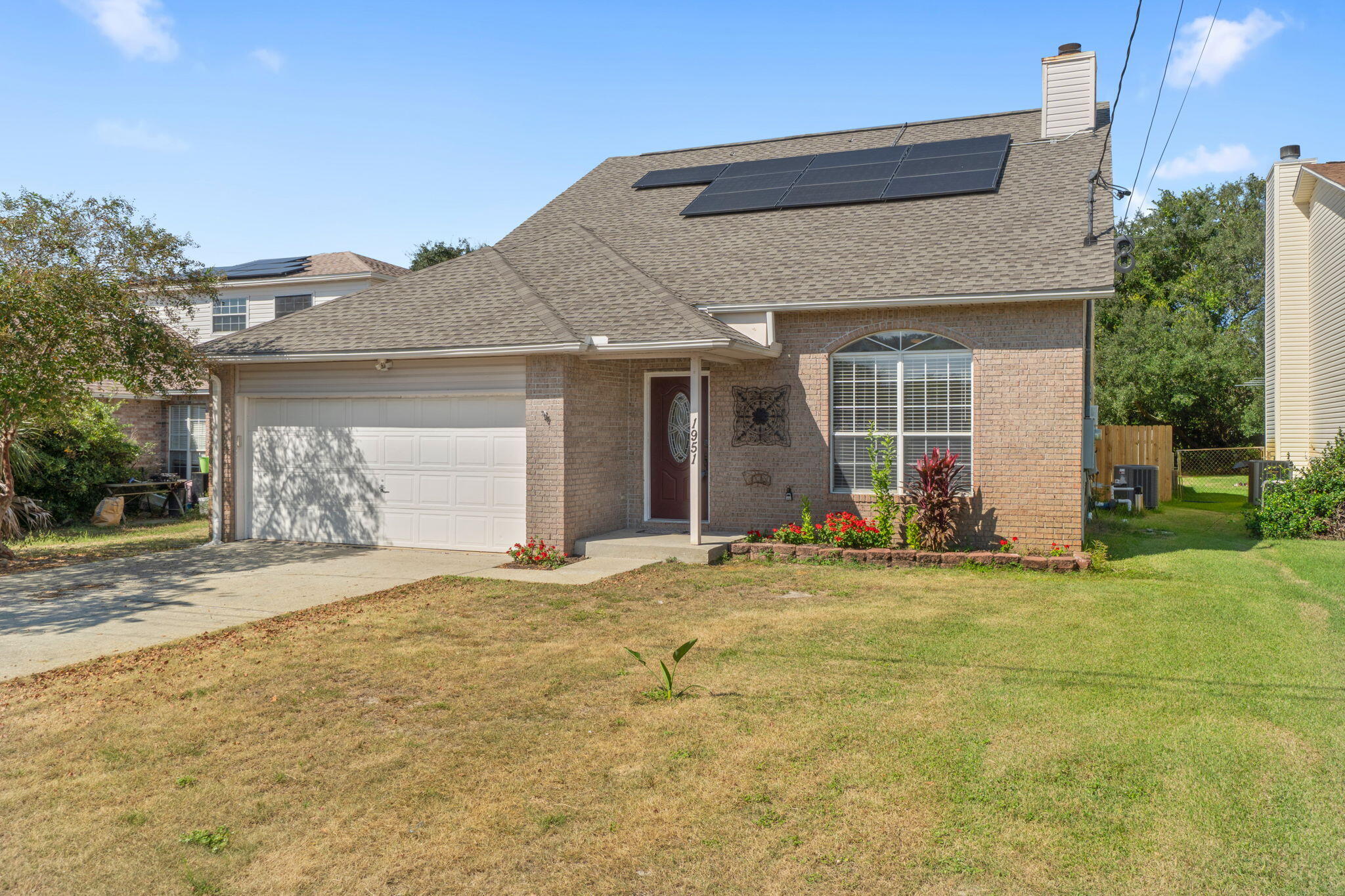 Welcome to this move-in-ready 4 bedroom, 2.5 bathroom home in East Navarre. Conveniently located just minutes from Hwy 98 and 87 - for easy commuting to I-10, local dining, shopping, grocery stores, and just 2 miles from the sugary white sands of Navarre Beach! Great location for local military bases, too! Just 10 miles to Hurlburt Field! This property features a 2022 Roof with paid off solar panels, a 2023 HVAC, and a 2017 water heater - ensuring peace of mind and low electricity bills! Through the front door of this split floor plan home, you enter the living room with vaulted ceiling that opens up to the second floor. Featuring a first floor primary suite with ensuite, laundry room leading to the 2 car garage, kitchen with breakfast bar, dining area just off the kitchen with a view of the expansive fenced-in backyard space, and a half bath for guests downstairs. The additional 3 bedrooms and full bathroom are up the stairs by the front door. Schedule your showing today!
