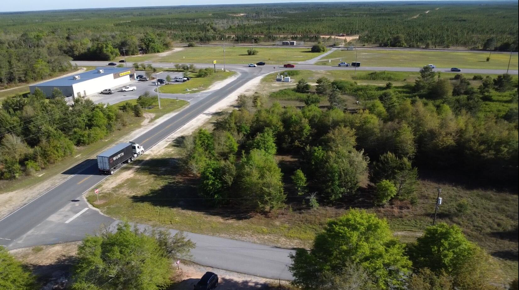 Great Prime Commercial corner site. Property is surrounded by 2 paved streets, Hwy 393 and Harielson Rd with visibility from Hwy 90. This property is perfect for multiple business opportunities with zoning being business general. Strategically located just north of the Shoal River Ranch, a major development site google 'Shoal River Ranch Gigasite' to see the 3d renders by the Economic Development Council and the latest info there (Link provided in agent notes). Drone video is available of this corner location. Property is being sold as is, includes the red metal building with concrete slab, as well as mobile home, no value given to mobile as there is no title conveying to mobile home. The wood privacy fence will be realigned to the current chain link fence boundary prior to closing.