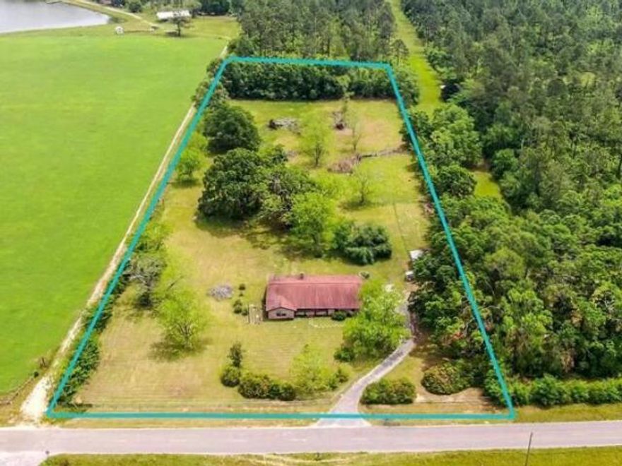 Escape to your own piece of paradise on 5 acres, where stunning sunsets and the tranquility of rural living await. This beautifully updated 3 bedroom 3 bath brick ranch style home is more than just a home; it's a retreat from the everyday hustle. Step inside to find spacious rooms filled with natural light, including a cozy family room with a wood-burning brick fireplace--perfect for chilly evenings. The kitchen is a chef's dream, with granite counters, stainless steel appliances, and a breakfast bar for casual dining. Enjoy peaceful mornings in the Florida room, overlooking your backyard oasis with pecan trees and a 28x32 pole barn. Need a space to call your own? The versatile bonus room(or office, or extra bedroom) offers endless possibilities. With modern upgrades throughout, this home