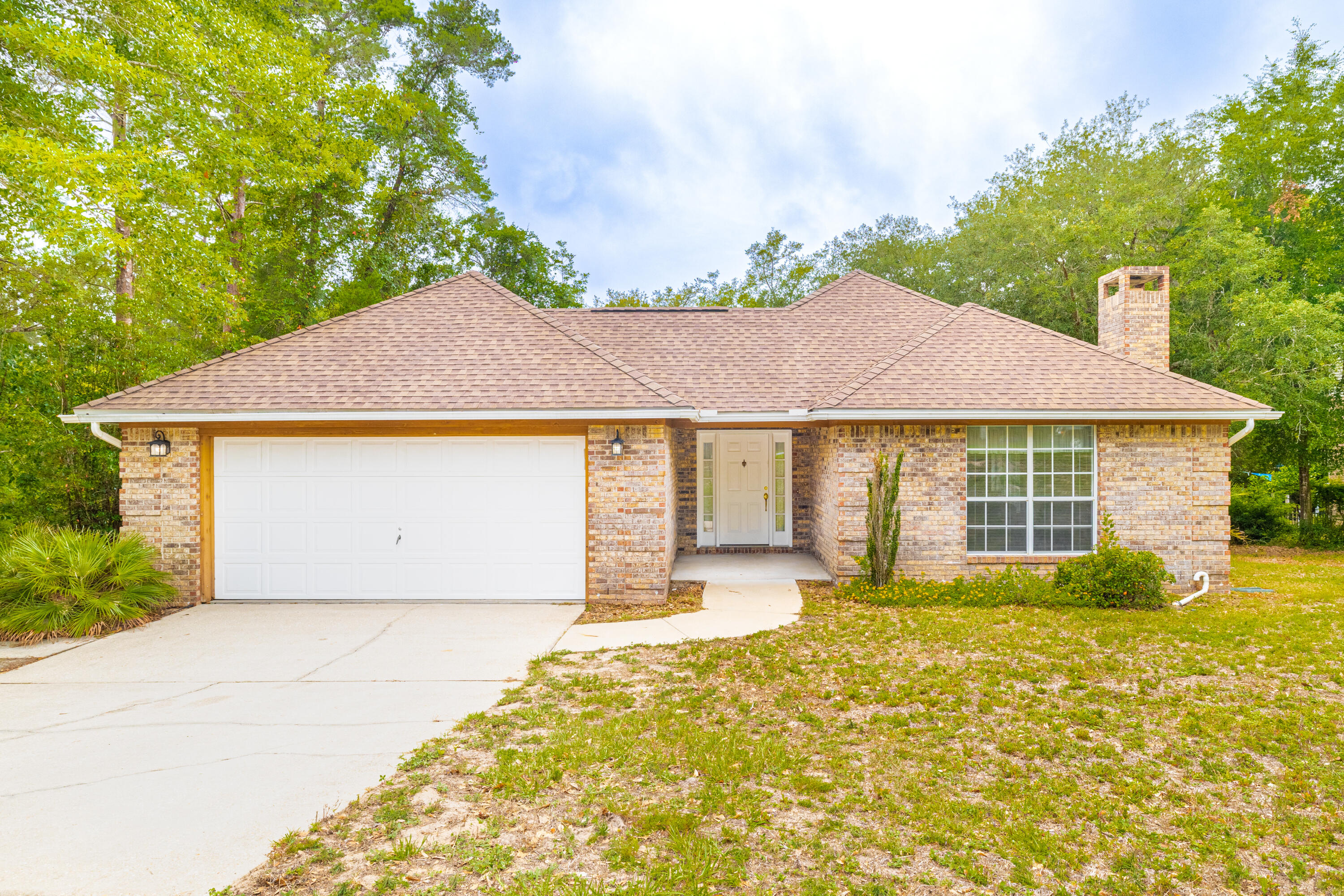 Wonderful home in the great area in Bluewater Bay in Niceville! One owner home on a huge private lot only minutes from the stunning Destin beaches! When you enter the home you will see vaulted ceilings in the great room and a nice fireplace centerpiece! Ample dining area and kitchen look out onto the great room. The partially covered side deck is a fantastic entertaining space just off the kitchen. The master suite is at the back of the home and looks out onto the private back yard with an ensuite master bath with double vanities. Two more bedrooms and another bath are located down the hall. A great screen porch is located off one of the spare bedrooms - this could easily be converted into conditioned space/office. No HOA. Roof 2010. HVAC 2018. Hip roof.