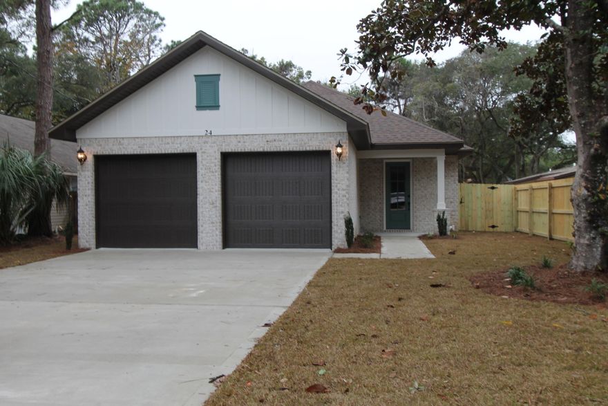 Awesome new plan! Golf cart friendly neighborhood, super close to shopping, downtown restaurants and 10 minutes from Destin. This 4/3 custom brick home has super curb appeal and is constructed on a deep lot with both large front and rear yards. There are 10 Ft. Ceilings w/ impressive crown molding, has LVP flooring throughout most of the home except for the wet areas which are tiled. At the rear of the living room/ dining area is the gourmet kitchen which boasts White cabinetry, Quartz countertops, a breakfast bar and stainless appliances (including an oversized commercial grade frig./freezer). There is also a stainless hood vent above the stove, that is vented through the roof. All cabinetry features soft close glides and hinges. A walk-in pantry is located at the left of the kitchen.