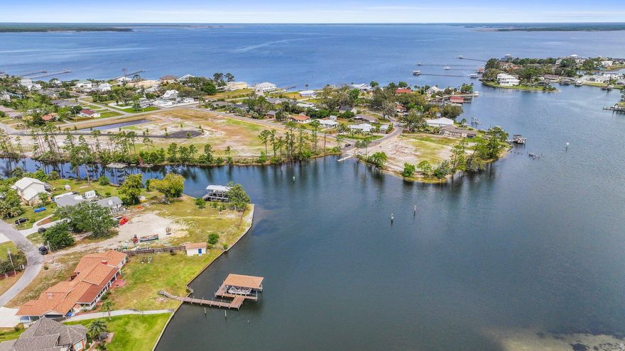 DEEP WATER ACCESS  BOAT DOCK WITH 10,000-LB LIFT CAPACITY  175 LINEAR FEET OF WATERFRONT  SINGLE-STORY HOMEWith three bedrooms (two with en suite baths), multiple living areas, two covered porches, and those GORGEOUS VIEWS, what's not to love about 2446 Pretty Bayou Blvd?This spacious home in a well-loved and established neighborhood is situated on the water near the end of a quiet cul-de-sac. In just a few minutes, you can be sunning on the white sandy beaches, dining in St. Andrews, listening to live music downtown, attending a play at one of the nearby colleges, or at work in one of our area hospitals, courtrooms, or schools.  The location truly is superb! The heart of this home is its living/dining/kitchen, which shows off the beautiful water views to great advantage. Cathedral ceilings add to the spacious feeling and flow. Stainless appliances, granite finishes, island seating, and additional eat-in space all combine to make everyday dining or special occasion entertaining easy and fun.

Need some privacy? You can find it in the carport-side den, in the windowed sunroom, or one of of the two covered porches out back.  Not one but TWO wood-burning fireplaces add to the coziness when temperatures dip down.

The master bedroom affords backyard access (and those water views!) via French doors. The en suite master bath features a tankless water heater, and the walk-in closet ensures organized dressing space for two.

The second bedroom is spacious with its own en suite bath, which is also accessible from the hallway. You'll find bedroom and bathroom number three and the laundry room on the other side of the kitchen.

Dock your boat right out back and enjoy sunrises and sunsets on the water any time.  From Pretty Bayou, you have deep water access to the North Bay, West Bay, and St. Andrews Bay, which then leads you out to Shell Island and the Gulf.

The large backyard can easily accommodate an in-ground swimming pool, fire pit, or any other entertainment space you can dream of. Grow some herbs or veggies in the raised beds, and store your gardening tools and boating gear in the roomy shed.  There's room enough for everyone's hobbies, making this home a playground and a haven.

Don't miss it!  Tour it today.