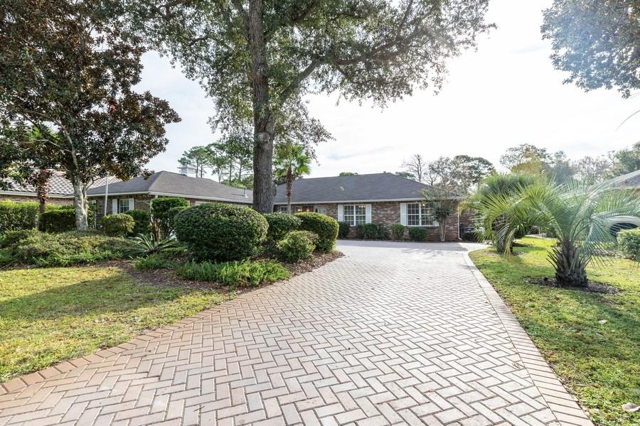 Meticulously maintained, this lakefront beauty is situated on .25 acres on the 7th hole of the Bay Golf Course in Bluewater Bay. Upgrades galore, this 3 bedroom, 2 bath home is complemented with paver driveway, Roof 2016, formal dining, large covered and screened-in patio area with heated gunite pool, vaulted ceilings in main living area, trey ceilings in the dining room and master suite. The kitchen has been updated with granite counter tops, custom cabinets, stainless steel appliances and a breakfast bar. Engineered hardwood in main living area, formal dining room, hall way and bedrooms. The master suite has been updated with dual sinks, large walk in closet, double trey ceiling and a custom tiled shower. Bedrooms 2 and 3 are both good size with large closets. This home is a must see!