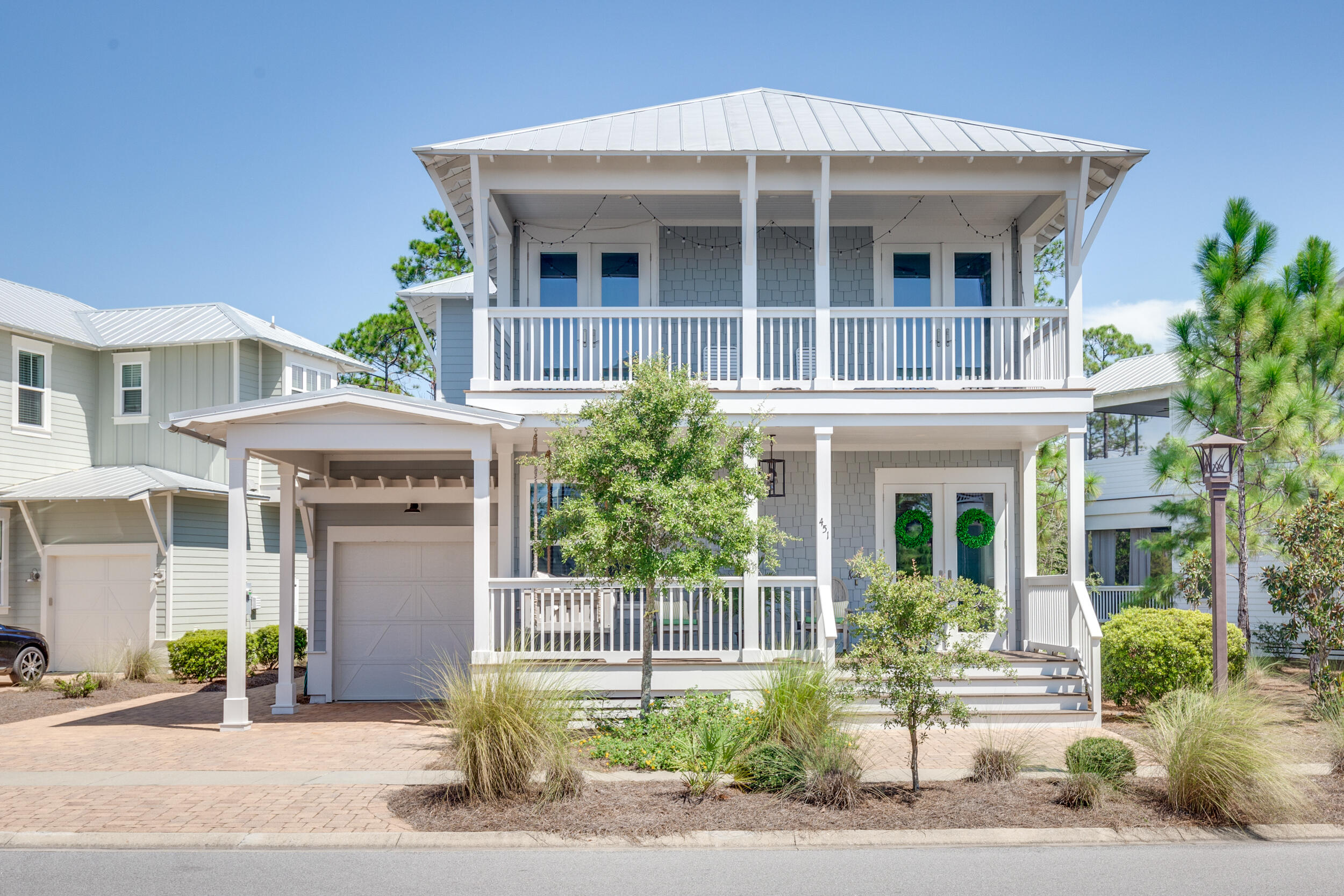 PRICED $125K UNDER THE LOWEST PRICED COTTAGE COLLECTION HOME (HOMES WITH PRIVACY BEHIND)!! Now being sold furnished! This homesite can't be beat! With a 77 foot front, it's the widest in the whole community and DOUBLE the width of the majority of sites in NatureWalk. The benefit = plenty of parking in the driveway, there's room for 4 cars! Also, plenty of room between neighboring homes, giving it a more private, pretty setting. Just sit back on the porch and enjoy the sounds of nature. Popular Wind Chime home with guest bedroom downstairs and wide open family, kitchen & dining. Custom, special touches have been added that you are sure to love- stained pantry door, linear gas fireplace with ship lap accent wall in family room, and stained header at the foyer of the house.