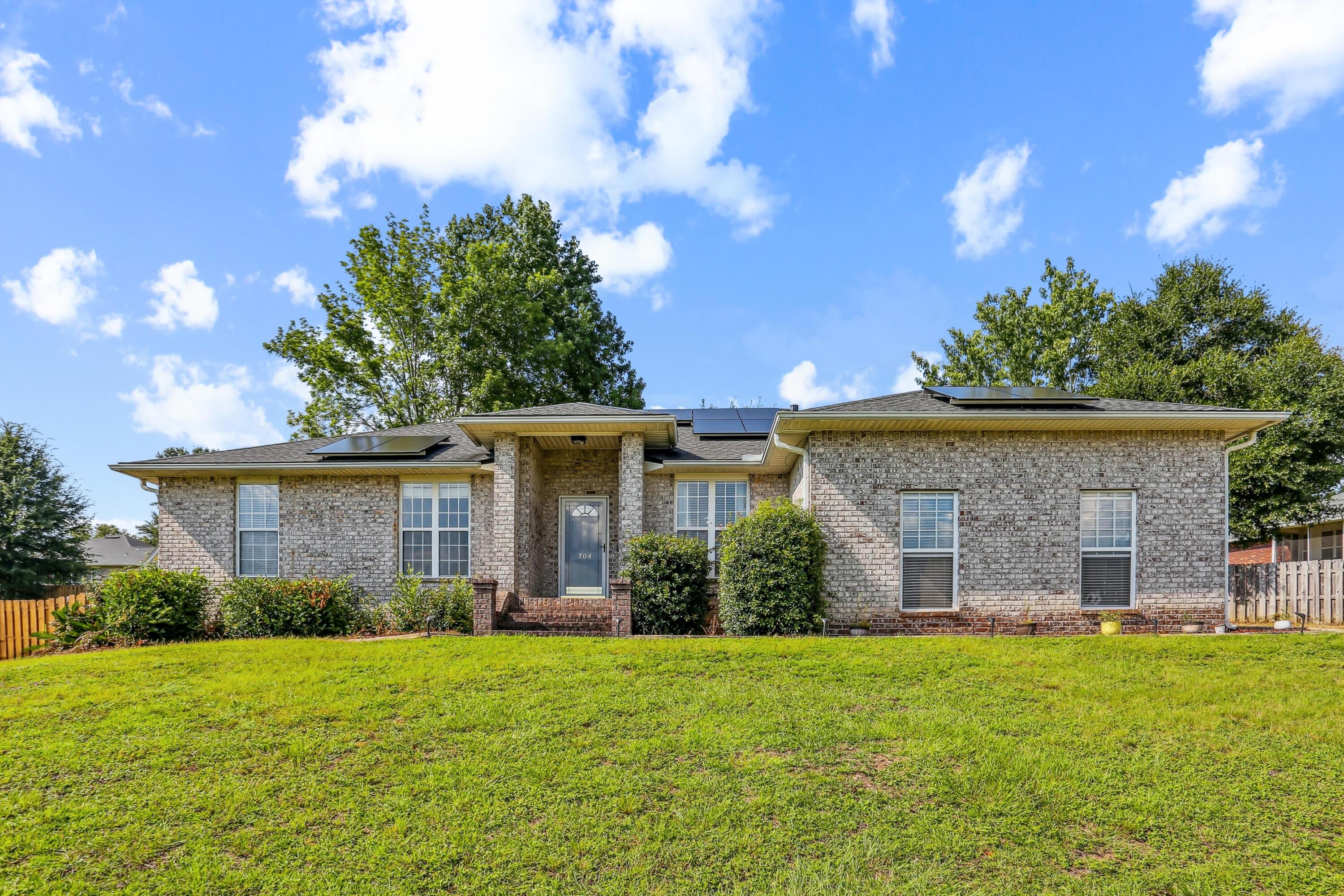 Now is the time to check out this beautifully updated all-brick home situated on a 1/4 lot in Antioch Estates - a great south Crestview location and will be very convenient to the future I-10 Exit 53! Move right into this split floorplan 4 bedroom, 2 bathroom home that includes a formal dining room! Gorgeous herringbone pattern wood-look tile throughout - no carpet! The living room has a cathedral ceiling with architectural niche and gas fireplace with unique stone accent! The stone carries over to the kitchen pillars with hop-up bar and also counter height breakfast bar seating. This kitchen is it!! - spectacular granite countersplash, upgraded cabinets with crown moulding & soft-close drawers, gas stove with hood, and stainless-steel appliances - -touch screen French door refrigerator included! The master suite is sizable with remote controlled blinds and an ensuite featuring a double vanity with granite countertop, walk-in closet, separate shower & garden tub. Head outside to your screened-in patio with new ceiling fan and the fenced backyard (with double gate access) also has a large shed. Lumio solar panels can be paid off with acceptable offer! Schedule to see this home today!