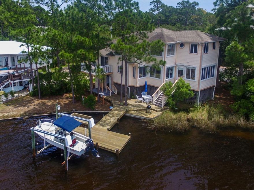 150' ON COASTAL DUNE LAKE AND SOUTH OF 30A! and it has a garage!!! Spectacular lake views from every room. Maple hardwood flooring thruout with tile in the baths. Owners have taken meticulous care of the house with great attention to detail. Most appliances are less than 3 yrs old, hurricane shutters which are easily lowered from the inside, new wood decking on the dock and much more. Two A/C systems, two W/Ds, security system, lots of storage on the ground floor.