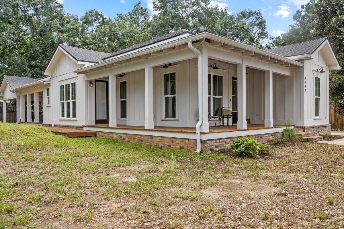 Stunning nearly new custom built New Orleans-style 3BR/2.5BA home with customized office, located in central Navarre, close to bases, beaches, and shopping. No HOA. VA assumable loan at 6%. Features a wrap-around porch with swing, 10-foot ceilings, and an open living/kitchen area. Kitchen has quartz countertops and custom cabinets. Natural light highlights the beautiful interior colors. Split floor plan offers privacy; the master suite includes a walk-in shower, custom closets, and soaking tub. HUGE lot and large yard for family fun. You will not find another home built as unique as this one!!! Schedule your showing today!