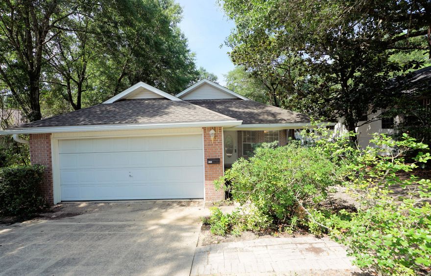 Quiet serenity awaits you in this custom home located on a wooded lot backing up to a delightful creek so you feel like you are living  in a treehouse! When you enter this home, you will notice the custom arches leading to a light and bright greatroom with a vaulted ceiling and sliding glass doors leading to a covered porch and a huge wrap around deck along the back of the house making this the perfect place for outdoor living. The kitchen features a unique 'pass through' to the greatroom as well as plenty of cabinet and counter space. The master suite has an updated bath with a large shower and the additional 2 bedrooms share another full bath. This home is move in ready with fresh paint as well as new LVP and carpet. Practical notes: Water Heater (2025), Roof (2015), HVAC (2007)