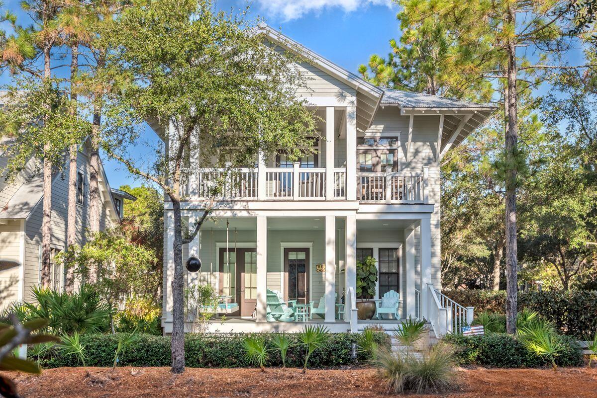 This beautiful beach house with its covered porches is enviably located on a corner lot in WaterColor.  The white cottage-style kitchen is fully loaded with quality appliances including a farm sink and Viking range with hood. Granite counters flow into a breakfast bar seating four. Imagine entertaining in this generous open space with vaulted ceiling providing an abundance of airy natural light. This upper floor enjoys excellent views through multiple sets of French doors and from the wrap-around screened balcony. It's the perfect place to chill out on loungers with a drink and look down on the world passing leisurely by.