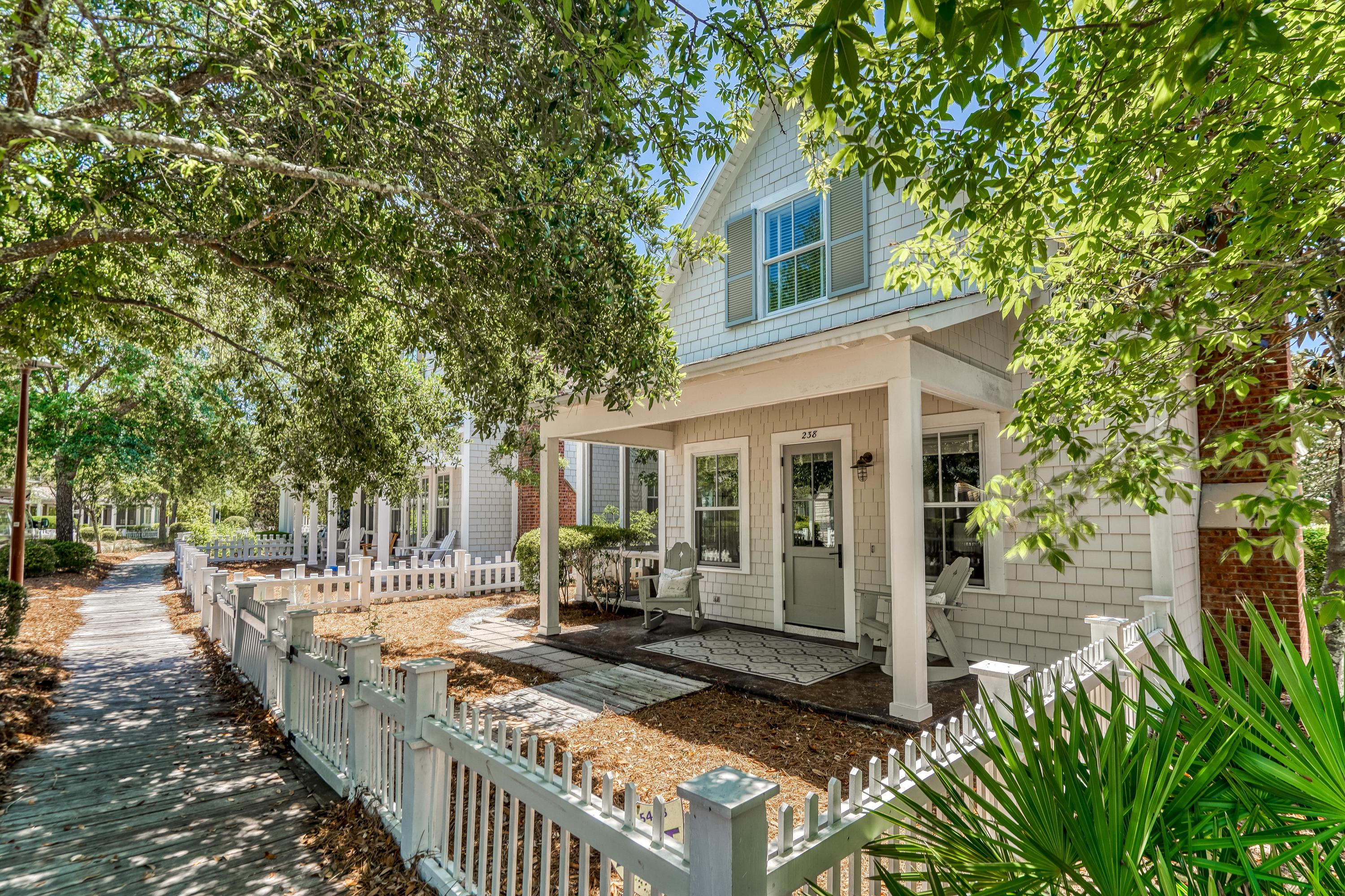 Bright & open spaces define this charming beach cottage complete with a white picket fence located only a short distance from the Gulf of Mexico in the gated community of WaterSound Beach. Cathedral ceilings, sun-filled windows & neutral wall colors allow this home to live much larger than its actual size. The kitchen features stainless steel appliances, granite countertops & a breakfast bar. The open living & dining areas are highlighted by a gas fireplace, wood floors & cottage-style millwork. Two master suites, on each floor both feature ensuite bathrooms. The first level also includes an office desk area with built-in shelving & a powder bath. An open front porch & screened porch off the dining area provide the perfect spaces to relax & enjoy the Gulf breeze.