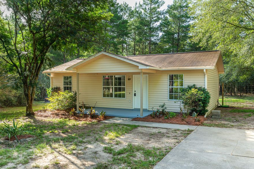 This adorable country home is surrounded by mature oaks, pines, and magnolias among many others. There is plenty of seclusion on this 4.77 acres of land. The home sits back off the road and is located on a cul-de-sac all the way at the end, so this is privacy at its best. There is a concrete parking pad with a sidewalk leading up to the freshly painted front porch. The interior of the home has also been freshly painted throughout with new matching doorknobs as well as new switch and outlet covers. The bedrooms had carpet removed and need new flooring however the remainder of the home has linoleum flooring throughout. All appliances including the washer and dryer will stay in the home. The kitchen appliances are stainless steel. The fenced in back yard is a huge plus and is a great