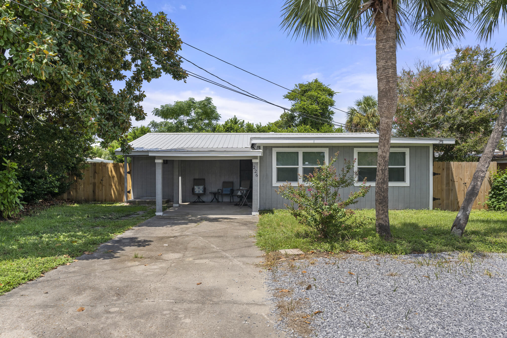 Welcome to 226 San Gabriel St, a charming single-family home nestled in the heart of Panama City Beach, FL. Built in 1960, this delightful residence offers a unique blend of character and modern convenience. With 1,313 sq. ft. of beautifully finished living space, it provides a cozy yet spacious environment perfect for comfortable living. The home features two well-appointed bathrooms and a range of recent updates that make it feel like new. Enjoy the benefits of a new durable metal roof, fresh flooring throughout, and a stylishly updated kitchen. The kitchen boasts elegant quartz countertops, a new backsplash, a sleek new sink, and modern cabinets. For added convenience, the home includes USB charging outlets and a Nest thermostat. The open and inviting layout includes a versatile Florida room, a convenient laundry room, and ample storage space. The property also offers a fenced-in backyard, ideal for outdoor relaxation and privacy, as well as a large parking area and a charming front door seating area where you can unwind. This home is situated in a peaceful and secure neighborhood with a no short-term rental policy and no HOA, ensuring a tranquil living environment. The front door lock has been upgraded to enhance security, and the interior has been freshly painted to create a welcoming ambiance. With its combination of timeless appeal and modern updates, 226 San Gabriel St is perfect for those seeking a quaint, well-maintained property in a highly desirable location. Walking distance to the World's most beautiful beach, Pier Park and the under Contruction attractions of Dolly's Pirate Voyage Dinner Show and Top Golf! Don't miss out on the opportunity to make this your new home!