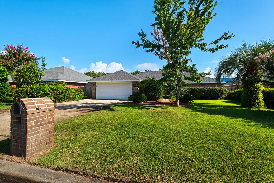Live the dream in highly sought-after Crane Cove! This beautifully maintained 3-bedroom, 2-bath contemporary brick home features a sparkling pool surrounded by lush tropical landscaping and vibrant greenery -- your own private paradise perfect for year-round entertaining and enjoyment. This kind of idyllic outdoor oasis would take years to recreate. Relax in the comfort of the expansive 448 sq ft screened patio, ideal for poolside lounging or dining al fresco! Inside, the split floor plan offers privacy and plenty of open space, with a spacious primary suite, featuring crown molding, two walk-in closets, dual vanities, a garden tub, separate shower and water closet. Natural light fills the great room, highlighted by a vaulted ceiling and a cozy corner fireplace.  The kitchen and breakfast nook overlook the pool and patio, creating a peaceful and inviting atmosphere. The kitchen includes an electric range, microwave, and dishwasher. A convenient hop-up breakfast bar adds seating and functionality. Freshly painted formal dining and front bonus room that offer versatile space, perfect for a home office or extra lounge area. Hardwood and tile flooring throughout provide timeless style and easy upkeep. Key updates- new architectural roof in 2023, new pool liner in 2024, seasonal pool cover / leaf net in 2024, and pool pump motor and Polaris were replaced in 2024.In addition, Govee Permanent Outdoor (programmable) Lights were installed around most of the perimeter of the house just in time for Holiday Season 2024. Large double-car garage, extra parking, sprinkler system, well, and a storage/gardening shed. Crane Cove offers underground utilities, street lighting and traffic light access for ease of entry. Located in the top-rated Gulf Breeze school district and just 10 minutes from Pensacola Beach and 5 minutes from Gulf Breeze Hospital and the Andrews Institute, this location blends comfort, convenience, and coastal living. Don't miss this piece of paradise in Gulf Breeze!