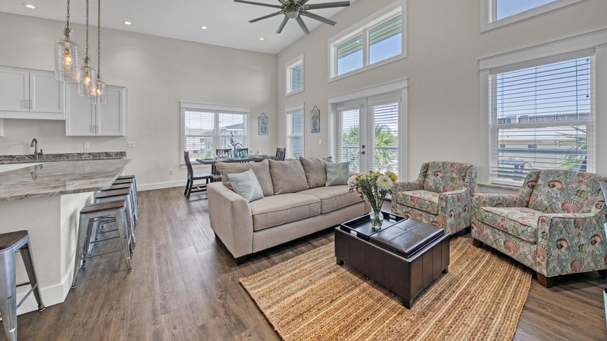 PRICE IMPROVEMENT! A rare gem -- spacious luxury townhome with a BOAT SLIP and TWO-CAR GARAGE! Stunning corner unit ideally located on Okaloosa Island, just a short walk to the beach and the serene waters of the Intracoastal Waterway. Designed for both comfort and entertaining, this home features an airy open floor plan with soaring 14' vaulted ceilings and expansive windows that flood the space with natural light. Plenty of room for entertaining after a day at the beach or a boat trip to Crab Island. Built in 2019, this is one of the newer properties on Okaloosa Island, boasting modern finishes and conveniences. Sold fully furnished and ready for immediate enjoyment. A 28' x 12' boat slip provides effortless access to coastal adventures.Buyer to verify all information deemed important