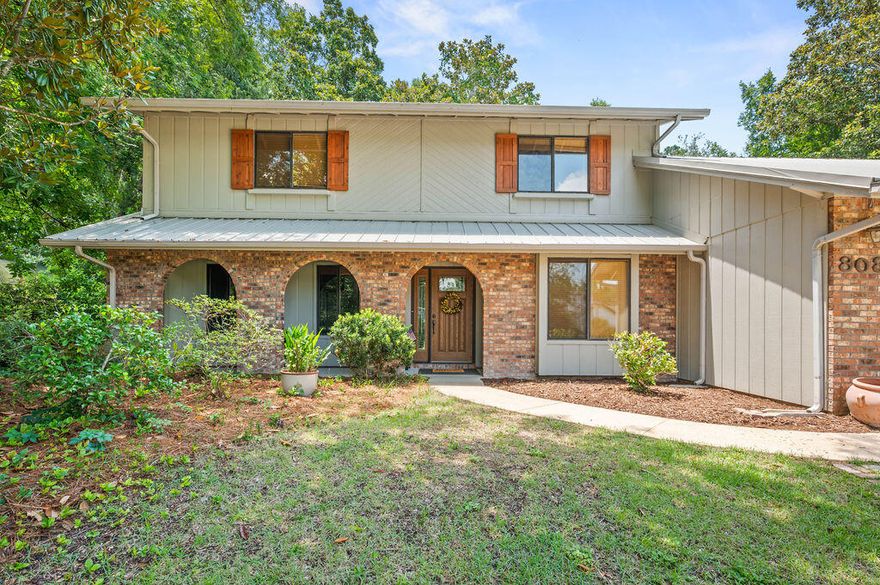 Charming, Well-Cared-For Brick Home with Character, Space & Entertaining Potential-This well-loved 1981 Florida home is full of character and timeless features, nestled on a generous .44-acre lot with a large front yard and a natural backyard filled with native plants offering privacy, shade, and a true Northwest Florida feel. The exterior pairs classic brick construction with wood siding accents, giving it warmth and curb appeal, highlighted by three distinctive front arches and a durable metal roof built to last. Inside, rich dark wood accents, classic wainscoting walls, and a beautiful, coffered ceiling add charm and craftsmanship you just can't find in most newer homes. The living room, dining room, and office/wet bar area are perfect for entertaining, offering a welcoming flow for gatherings of any size. The primary suite features a cedar-lined walk-in closet and a clawfoot tub, adding a touch of vintage elegance. The home has been thoughtfully maintained with updates including a 2024 water heater, 2015 HVAC, new guest bathroom tub, and newer exterior sliding doors. Homes with this kind of character, lot size, and a 3-car garage are increasingly hard to come by. Whether you love the classic details as-is or envision making it your own, this property offers the perfect combination of charm, space, and potential all with the inviting feel of Northwest Florida. All information is believed to be accurate but buyer must verify any information deemed important. 