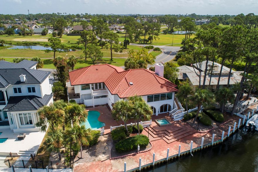 Welcome home to your coastal retreat. Imagine uninterrupted Grand Lagoon views and being able to park your boat in your backyard on a private 110ft dock. Unparalleled water views from nearly every room in the home. A thoughtful and complete renovation while also preserving the charm of custom finishes. Offering duel kitchens and top of the line Viking and Subzero appliance packages. Exterior improvements include a new roof, plumbing fixtures and electrical throughout. This stunning Master bedroom and bathroom gives all the spa like feelings featuring beautiful marble floors and walls, duel bathrooms and closets, a steam shower and separate soaking bathtub with a fireplace and bay view! (see additional remarks)