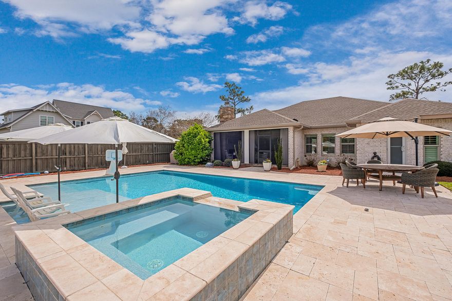 POOL HOME IN PELICAN BAY GATED COMMUNITY!!! Beautiful home with a 30'' x 15' heated Pool w/ Hot Tub and 8' Sunning Deck. Like new custom built home with NEW FLOORS throughout and a 3 CAR GARAGE! Sitting on a large corner lot in a gated community with low association dues, this home will not disappoint because of all the upgrades and extras for your enjoyment. Enter on a brick paver circular driveway with an oversized three car garage with ample storage. A desirable open floor plan, a chef's kitchen including 5 burner gas cooktop, Quartz counter tops, stainless appliances, microwave drawer, custom cabinetry with under cabinet lighting, tile back splash, and breakfast bar. with sliders that open all the way to a screened porch with a SUMMER KITCHEN, a SECOND GAS FIREPLACE, infrared heaters in ceiling, and tongue in groove wood ceiling. 

Entertaining will be a breeze with a professionally installed sound system for outdoor living space, living room, master bath and garage. The master suite offers two walk in closets,(one used as an office), the other with a custom closet system. The large walk in shower has a door leading outside to the expansive POOL area. The guest bath has double vanities. Professional landscaping gives this home a fantastic curb appeal and low voltage lighting around the exterior makes this home standout and shine at night. This home also offers two water heaters and extra foam insulation. Pelican Bay offers a private bay front park with a new dock and swim platform and a soon-to-be-resurfaced Tennis Court & 4 Pickleball Courts overlay w/ Professional Nets. Don't miss this opportunity to own this custom built home that is in immaculate condition. Buyer to verify all dimensions.
