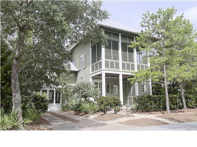 Coastal sensibilities intersect effortlessly with classical proportions and sophisticated modern lines in this elegant home overlooking Western Lake in WaterColor. A true artist collaboration among the talented Bates & Corkern Architects and designer Liz Hand Woods of Birmingham, this three-story home fosters an ongoing relationship with nature and outdoor living. A sheltering front porch presents a traditional welcome to the street, while a sliding barn door beckons visitors into a generous breezeway and a private courtyard with a pool and outdoor showers tucked within a lush natural landscape. Interiors offer equally engaging gestures befitting the waterfront setting. A generous family room