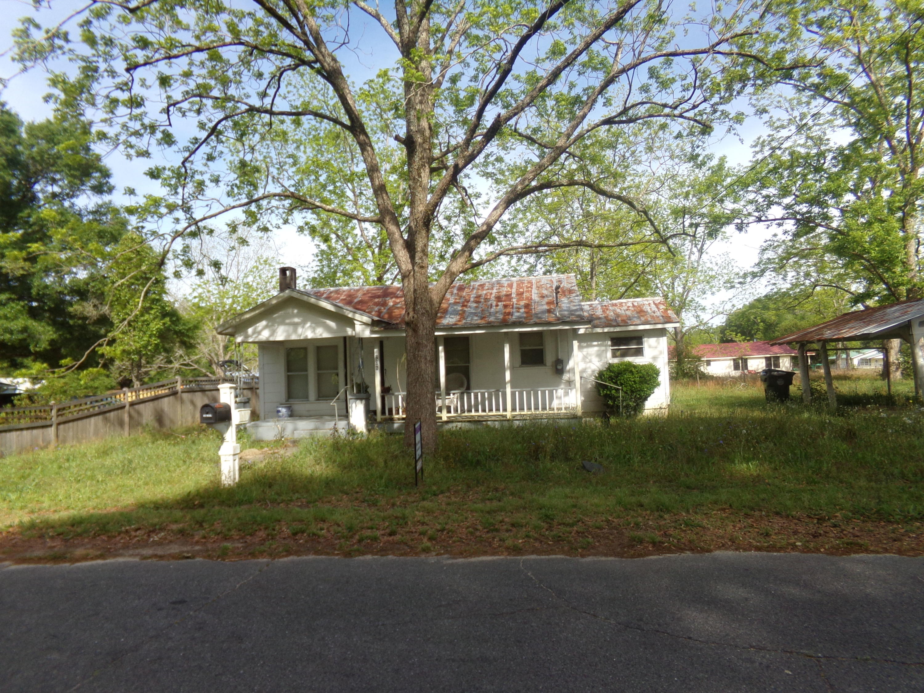 Small Florida Cottage being sold AS IS~ 3 bedroom 1 bath with combination wooden walls & ceilings with some drywall~ The seller has drywall for wall repair stacked in the house~ The house needs work and is being sold as is~ There is 22 x 14 shed in the back and a carport to the side~