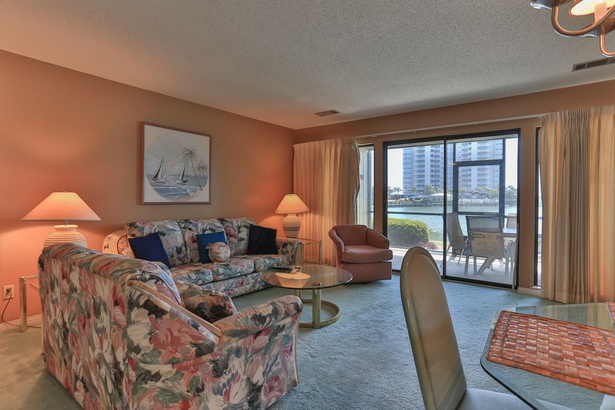 Sit and enjoy the view of Stewart Lake from the living area, kitchen and large screened-in porch. The open floor plan offers lots of storage plus an additional small sink at the entrance to the kitchen. This first floor unit is steps away from the swimming pool and the beach boardwalk. Seascape has deeded beach access. Seascape Resort has gated entrances, 18 hole golf course, tennis courts and pools. The Seascape Towne Centre offers restaurants, fun activities and shopping. All dimensions and information herein is deemed reliable, but should be verified by buyer.