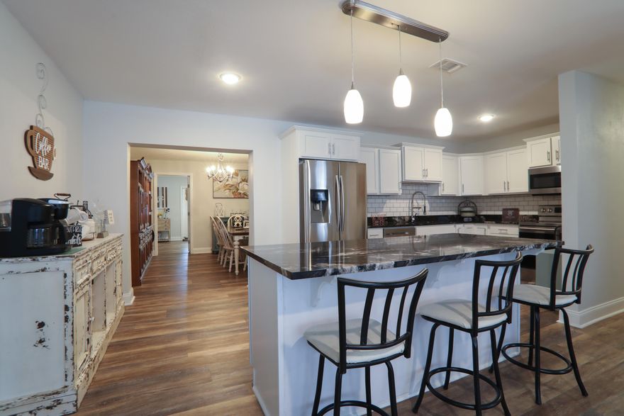 You must see this breath-taking home!  This gorgeous home is located in the heart of Fort Walton Beach and has been completely remodeled.  This spacious and stunning 5 bedroom/ 3 bath ranch home will wow you with an open floorplan and modern features.  You will enter the home into a spacious kitchen/living area that provides custom lighting, extensive granite counterspace, custom backsplash, stainless steel appliances, oversized breakfast nook, engineered hardwood flooring, and cabinet space for all the essentials.  The kitchen flows elegantly into the large dining area for guests or any large gathering.  This oversized primary suite features a walk-in closet, granite two sink vanity, and a tiled walk-in shower.  2020 roof, and 2019 AC. Effective year built is 2005. Second bath provides convenient access to the spacious two additional bedrooms ready for your ideal design.  The backyard hosts a private oasis that features a large area to relax, space for a pool, or storage shed to fit your growing needs.  Only a short drive to many of our top beaches in the area and shopping venues alike.  Don't miss the opportunity to own this amazing home so schedule your viewing 