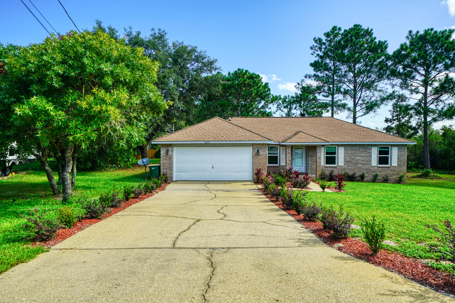 HUGE 1.5 acre double lot in Navarre! If you are looking for some wide-open spaces, you've found it! Very nicely updated 4-bedroom, 2 bath home has NEW carpet and padding, NEW high-grade double slab granite countertops, NEW garbage disposal, and features a pantry, eat-in kitchen nook overlooking the spacious backyard. The 20x20 two car garage features NEW epoxy flooring, Genie Garage door opener and three remote fobs. Master bedroom is large and the ensuite has dual sinks, oversized linen closet, soaking tub, walk-in closet, and NEW mirrors, NEW toilet and NEW mirrors, NEW fixtures! Let's keep going shall we? NEW ceiling fans throughout, NEW E-Rated tinted windows with hurricane fabric, NEW Sherwin Williams Super Paint, NEW 12x12 deck pressure treated back deck!