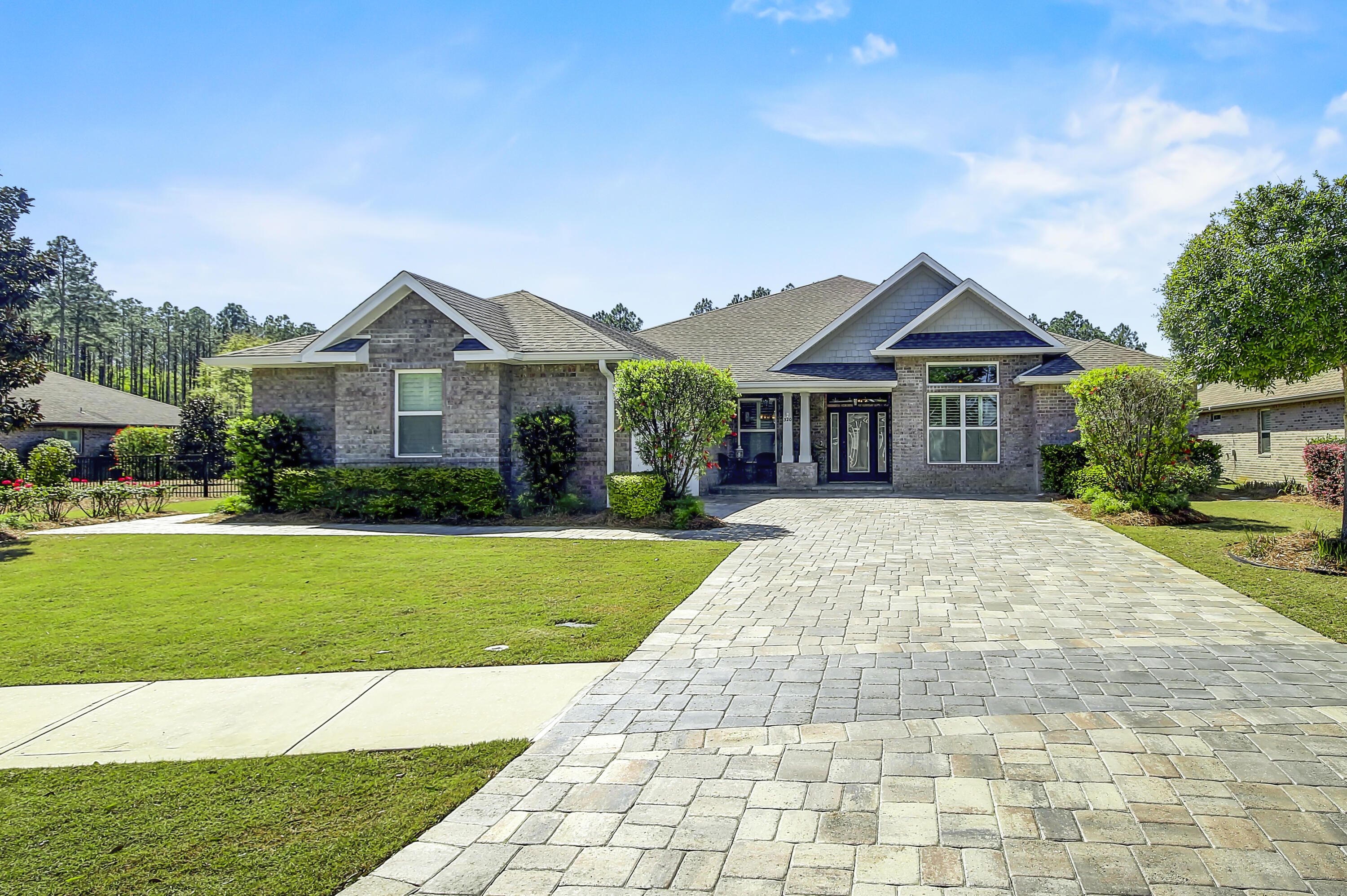DOUBLE LOT !!!METICULOUSLY MAINTAINED ELEGANT WATERFRONT HOME WITH MATURE FRUIT-PRODUCING CITRUS GROVE IN SYMPHONY AT HAMMOCK BAY! A rare .6 acre homesite providing one of the largest lots in Hammock Bay and a Lakefront setting like no other. This 4 bedroom 3 bath home has pride of ownership written all over it. Luxurious bead board cabinets with installed sliding shelves throughout, gorgeous hardwood floors, matching high-end quartz countertops throughout, fully finished large laundry room with built in sink, hop up breakfast bar, walk-in pantry, Butler's Pantry, top of the line plantation shutters in every window, upgraded fixtures throughout, dedicated media room.