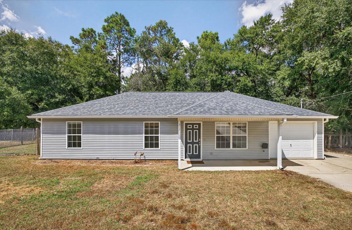 Set on a spacious half-acre lot in the heart of Crestview, this 3-bedroom, 2-bathroom home offers both comfort and room to grow. The living room with vaulted ceiling. Eat-in kitchen featuring stainless steel appliances and plenty of cabinet space.Flooring has been updated with LVP in the living room and hallway, tile in the wet areas, and carpet in the bedrooms. The bathrooms have a modern feel, featuring vanities with rich espresso cabinetry and updated finishes.Additional highlights include a large laundry room with washer/dryer hookups, and a one-car garage. Located within a short commute to schools, shopping, 7th Group, and Duke Field.