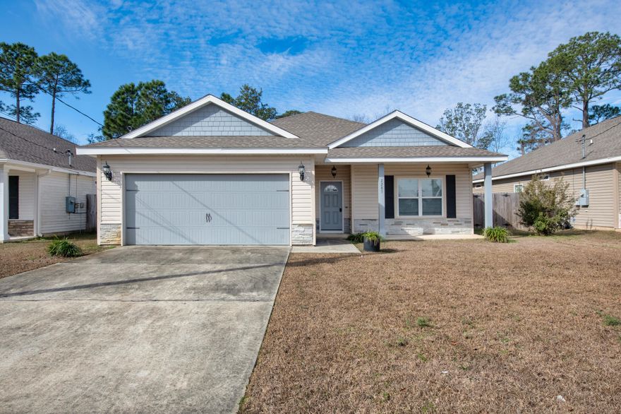 Discover this thoughtfully maintained one-story home located in the heart of East Navarre. Spanning roughly 1,600 square feet, the home offers three comfortably sized bedrooms and two full baths in a functional, open layout. A spacious main living area connects to the dining space and a bright kitchen designed for both cooking and gathering, featuring granite countertops, stainless steel appliances, custom-built cabinetry, and a breakfast bar with room for casual seating. The primary bedroom sits privately at the rear of the home and looks out over the backyard. Its attached bathroom includes a double-sink granite vanity, tub and shower combination, and two walk-in closets for generous storage. The additional bedrooms are larger than average and offer plenty of closet space. Tile flooring runs throughout the home, complemented by ceiling fans in every bedroom, window coverings already in place, and a refrigerator that remains with the property. This move-in-ready home blends comfort, space, and convenience in a desirable location.