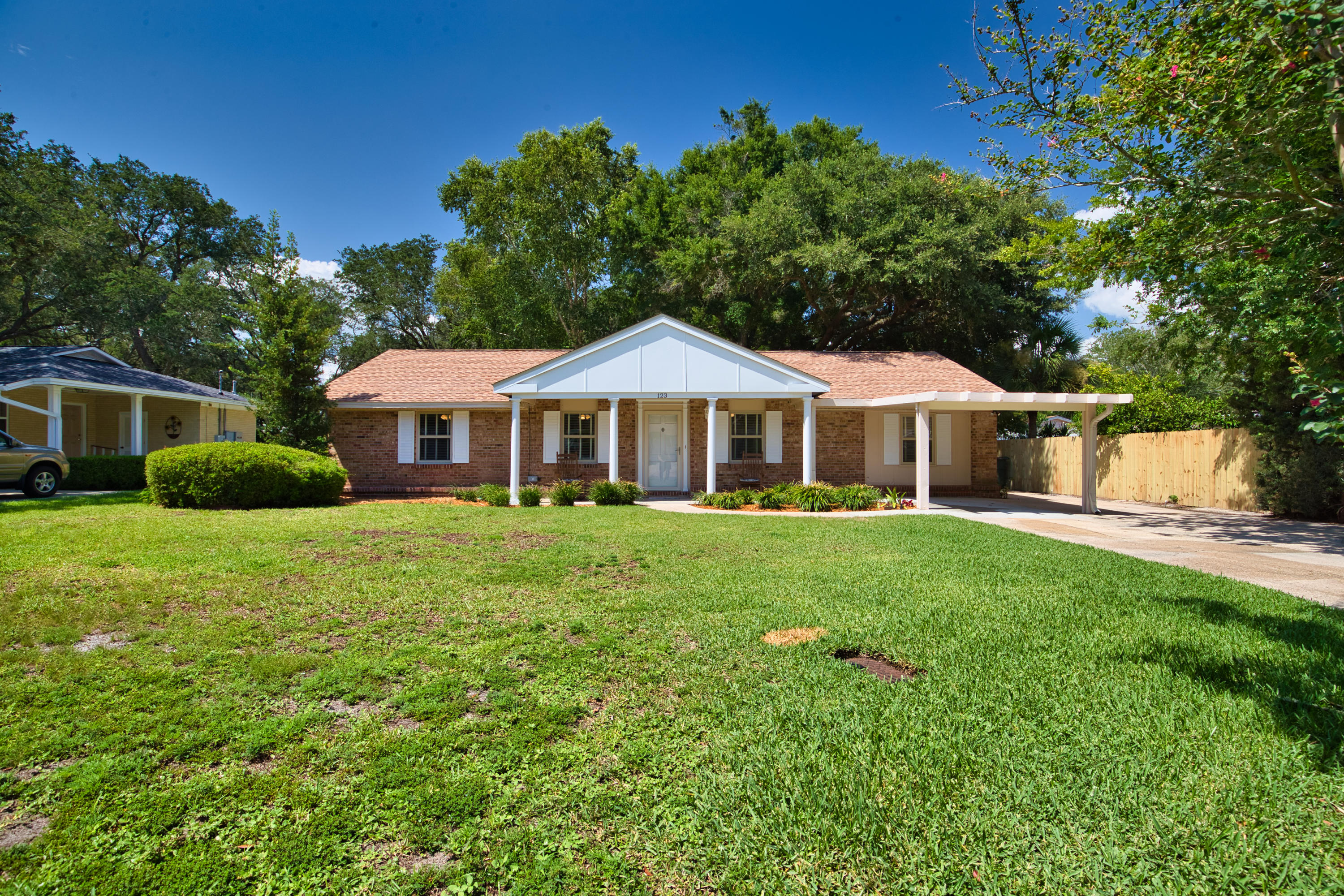 A MUST SEE!! Totally renovated and move-in ready 3 bedroom, 2 bath home. Open floor plan with a huge Kitchen boasting all new cabinets, granite counter tops, high end back splash with stainless steel appliances. Home also has new updated Pex Plumbing and new Electrical including LED CAN lighting! Much love went into this home with many upgrades including but not limited too - new gas water heater, pendants, ceiling fans, luxury vinyl plank flooring, new carpet etc. Master bathroom featuring Carrara marble and walk in shower (Shower glass to be installed). Exterior is equally impressive with over-sized parking area with carport and retractable awning on the side. Enjoy this spectacular back yard from your Florida room with new sliding glass doors and additional 14 sear mini split