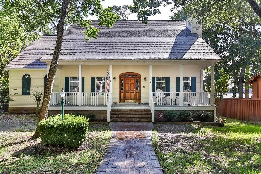 AMAZING home on the protected deep water of Boggy Bayou with an awesome sunset view! This completely updated southern cottage style home welcomes you home with its charming front porch complete with rocking chairs. When you enter the home through the wide front door you get a wonderful ''welcome home'' feeling enhanced by the warm wood floors. To the left of the foyer is the living room that is used as an office and to the right is the formal dining room with a cozy wood burning fireplace accented by 10' ceilings. Next to the dining room is the oversized kitchen with plenty of counter and cabinet space and wonderful views of the bayou. The large breakfast area is the perfect place for family meals overlooking the water through the bay window. The family room is open to the breakfast room