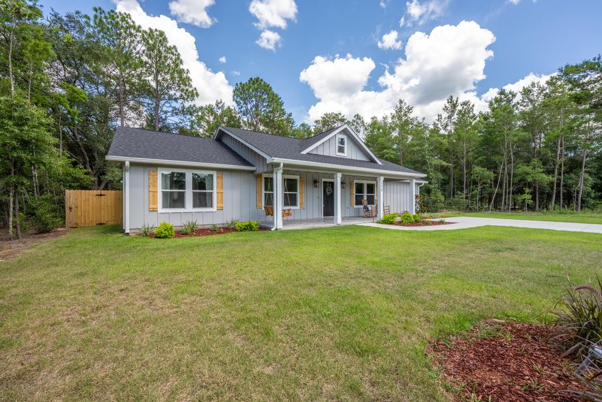 Welcome to your NEW home! This beautiful home has so many upgrades! Split bedroom floor plan-check! Massive master bathroom with custom tiled shower, separate throne room & a closet dreams are made of--check! Country setting (with a couple adorable cows across the street)--check! This home checks all the boxes. The family chef will be pleased with the large kitchen, featuring a gas stove, white soft-close cabinets topped with classic quartz and a fancy faucet (it lights up!), big pantry to store your stand mixer and air fryer, etc. The island IS an island, with over 9 ft of bar seating, herringbone tile work, and a plethora of counter space. The kitchen opens to the dining and living room, with access to the back porch, perfect for entertaining guests and hosting holiday meals. Soaring ceilings make the home live even larger! Step into your Country era with the shiplap accent wall, and the convenience of the modern gas fireplace. The laundry room has cabinets with butcher-block countertops and a perfect spot for a deep freezer. Adulting is not a beige flag with an energy-efficient tankless gas water heater.  

Character and fine craftsmanship abound! The porcelain-tile work is incredible, seamless transitions from living space to bathrooms--no carpet for ease of cleaning and reduced allergens. Classic craftsman style wood trim dresses each window, board and batten exterior is beautiful and made to last with concrete fiber board. Barn door detail at the first bedroom (office), an apron sink in the kitchen and 3 panel white doors add rustic charm. Big windows let in lots of natural light, and LED lights are easy on the power bill while keeping things lit. You'll enjoy morning coffee on your front porch swing (245 sq ft front porch) and listen to the crickets in the evening with a cold drink on your covered back porch (200 sq ft). The back yard has lots of trees for your enjoyment, and the septic tank was placed in the front, just in case you'd like to put in a pool. There is a custom built storage shed/workshop in the back yard, approximately 16 x 12 ft with 8 ft ceilings, power and a workbench! The shed is painted to complement the home and will accommodate your tools and yard implements in style. This new build features several upgrades that most don't: gutters, sprinkler system and a privacy fence! This home has great design, quality craftsmanship, and is conveniently located in the beautiful Mossy Head area, just about 3 miles to the I-10 access point at Hwy 285. Only about 14 miles to growing historic downtown DeFuniak Springs, famous for its perfectly round spring-fed lake; (did you know Walton County has more than 40 lakes?!) about 31 miles to the sugar white sandy beaches of Destin! Peaceful living is yours to enjoy with recreation and nearby amenities. Make this one your Home-Sweet-Home!

All information believed to be accurate, buyer to verify all facts deemed important.