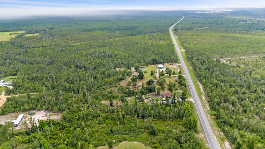 Embrace the charm of country living with this affordable opportunity in Timber Run Estates, Youngstown, Florida. Nestled south of Fountain, FL and northeast of Lynn Haven and Panama City, this locale offers a blend of serenity and accessibility. Minutes from Tyndall Air Force Base, it accommodates various lifestyles. Neighbors on adjacent properties foster a sense of community.Lot 55, Block A, offers 1.23 +/- acres with 109 feet of frontage on Highway 2301. This is your canvas for a cozy home, mobile home, or modular home - tailored to your budget and dreams.Frontage Spanning 109' across Hwy 2301 at 370' deep this lot sits nestled in District 55, unincorporated Youngstown, amidst a small-town atmosphere where community matters. Zoned Agriculture 2 (1 unit per 20 ac), with extensions from Agriculture 1, envision your own space within nature. A single-family dwelling is possible, is inviting you to create a snug haven surrounded by the tranquility in the country.

Appreciate the positives: Despite mostly sitting in Flood Zone A with wetlands, these features are embraced here. Enjoy a 30-foot buffer around the wetlands, showcasing the beauty of nature. While wetlands typically raise concerns, they become assets when approached creatively. A true wetlands delineation study could open doors to unlocking this lot's hidden potential.

Investing in your future is within reach. 

Gulf Coast Electric Coop serves the area. No gas, public water, or sewer is available - a chance to explore self-sufficiency. 

Private Well - needed.
Septic - needed.
Gas - Propane tank needed. 

Education and convenience meet here. Waller Elementary caters to the young learners while Northwest Florida Beaches International Airport is a mere 21 miles away. Public beach access, just 30 miles away, brings relaxation to home and away.

For outdoor enthusiasts, the Ecofina Creek Canoe Livery awaits to the north. Begin your journey down 7 miles of the Ecofina, embracing nature's splendor.

Turn dreams into reality with Lot 55. Your country living journey starts here. Connect with us to explore this affordable gem, ready to shape into your very own haven.