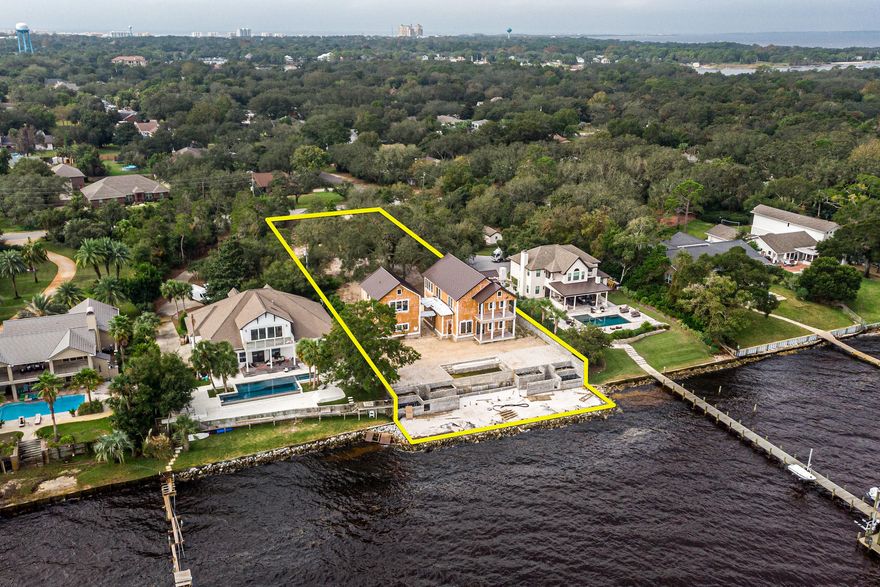 Rare opportunity to acquire one of the most superb waterfront estates in Destin, Florida, 100' of which fronts the scenic Choctawhatchee Bay!  This new construction offers a unique opportunity for a buyer to acquire a project of profound structural integrity, owned by a seller who has the utmost care and concern for quality and craftsmanship.  Perched atop one of the highest elevations in the area, this .88-acre compound is oriented for convenient and private access on the preferred west end of Indian Trail.  Magnificent live oaks grace the site, setting the perfect stage for a stately drive meandering through the indigenous landscape, leading to your new 3,850 SF home and carriage home, as well as your two-car garage, pool, beach, and...