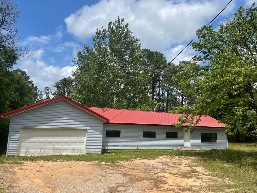 Freshly painted with new flooring and updated kitchen, this home is ready for new owners. This mobile home has been updated with 2016 Hot water heater, newer AC unit, and 2018 Metal roof.  A garage and huge back patio have also been added to this home.  You will love that the lot is on a cul-de-sac street with mature trees.  Over half an acre.  There are no HOA dues. This home features large kitchen and spacious rooms.  Wildlife is abundant in the back yard.   Come out and see all of the potential that this home has to offer.