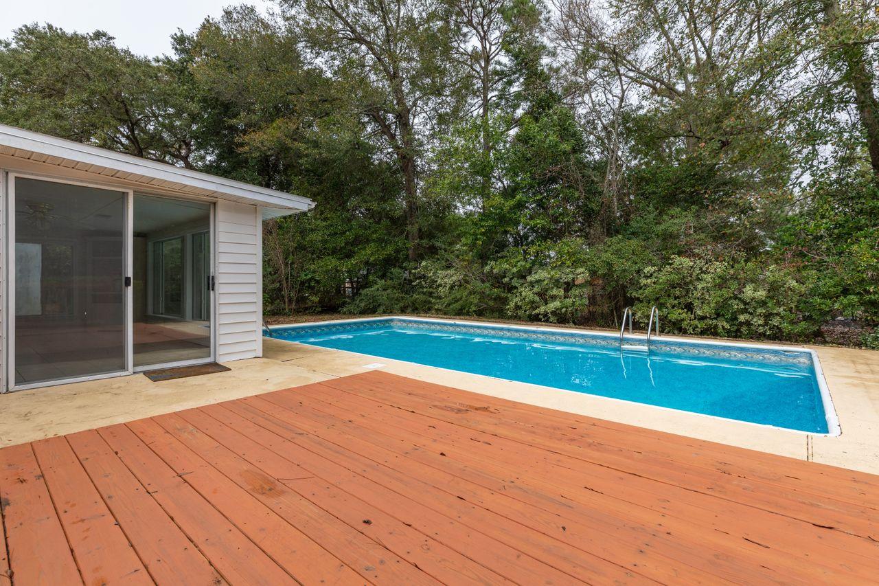 Amazing Opportunity to own this beautiful brick home in sought after Colony Estates. Plenty of living space with 3 living areas- a living room with built-in shelving, family room with flagstone wood-burning fireplace, and a bright and open Florida room that overlooks a 16x32' in-ground pool!Need storage? You'll find a large (8x16) metal storage shed, garage, and covered carport for parking. This home is move-in ready. Seller is offering a Home Warranty. Must see!