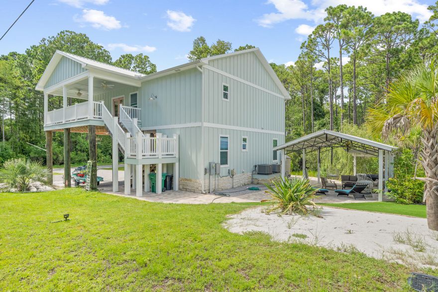 This beautifully built 2-story home, nestled on a corner lot, offers a serene country feel with its lush trees, yet it's conveniently located right off 30A. NO  HOA! The property has never been rented but is ideal for short-term rentals. The beach is just a short distance away, and the aerial view highlights the ample parking space and closeness to the beach. Inside, the home features 2 bedrooms downstairs, a full bath with a laundry room, a touch-turn-on glamor mirror, and front loader washer and dryer. The upstairs area is perfect for entertaining, boasting a spacious living room with a large seamless window that offers stunning views of nature--perfect for watching deer as if they were on TV. Notable features include wood-beamed ceiling, gas fireplace, large kitchen with a... breakfast nook, a quartz countertops, and a pantry with barn doors. The master bedroom comes with a luxurious full bath that includes an air-jetted tub with changeable LED lights, a separate shower, touch-turn-on glamor mirror, and a double vanity. The fourth bedroom has an adjoining gorgeous full bathroom with a double vanity. It is accessible from the living area as well. The outdoor area is an entertainment oasis with a vast 2nd-story covered porch and a ground-level entertainment mecca gazebo complete with a hot tub, an outdoor shower around the corner, and a storage building. Additionally, the sale includes a 6-seater golf cart, hot tub, and most indoor furniture.   The location is within three blocks of the bike path on 30A!! Nearby you will find Nick's restaurant and Blue Mountain Creamery, beach accesses to the East and West on 30A, Grayton Beach's Famous Red Door, Basmatis, Grecian Gardens, Local Catch, Cafe Tango, and Goatfeathers. A little further along is Gulf Place center - home of Miss Lucille's Gossip Parlor and great shopping - making this home a truly exceptional find.