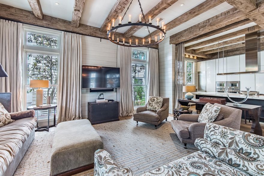 Find a refined yet comfortable atmosphere from the moment you enter this elegant WaterColor retreat with a 5BR main home, a 1BR attached guest home and a two-car garage. Conveniently located in Phase III across from the Frog pool, this property impresses with fine finishes at every turn including exposed antique ceiling beams, 100-year-old reclaimed white oak floors, Calcutta Gold polished marble counters and Pecky Cypress interior doors. Gather in the expansive and airy living and dining spaces highlighted by multiple seating areas, a dramatic stone fireplace, shiplap walls and floor-to-ceiling windows and doors. The stunning kitchen will wow any chef with luxury appointments such as a white Poliform Italian cabinets, a Gaggenau Hausgerate Vario gas cooktop, double ovens and