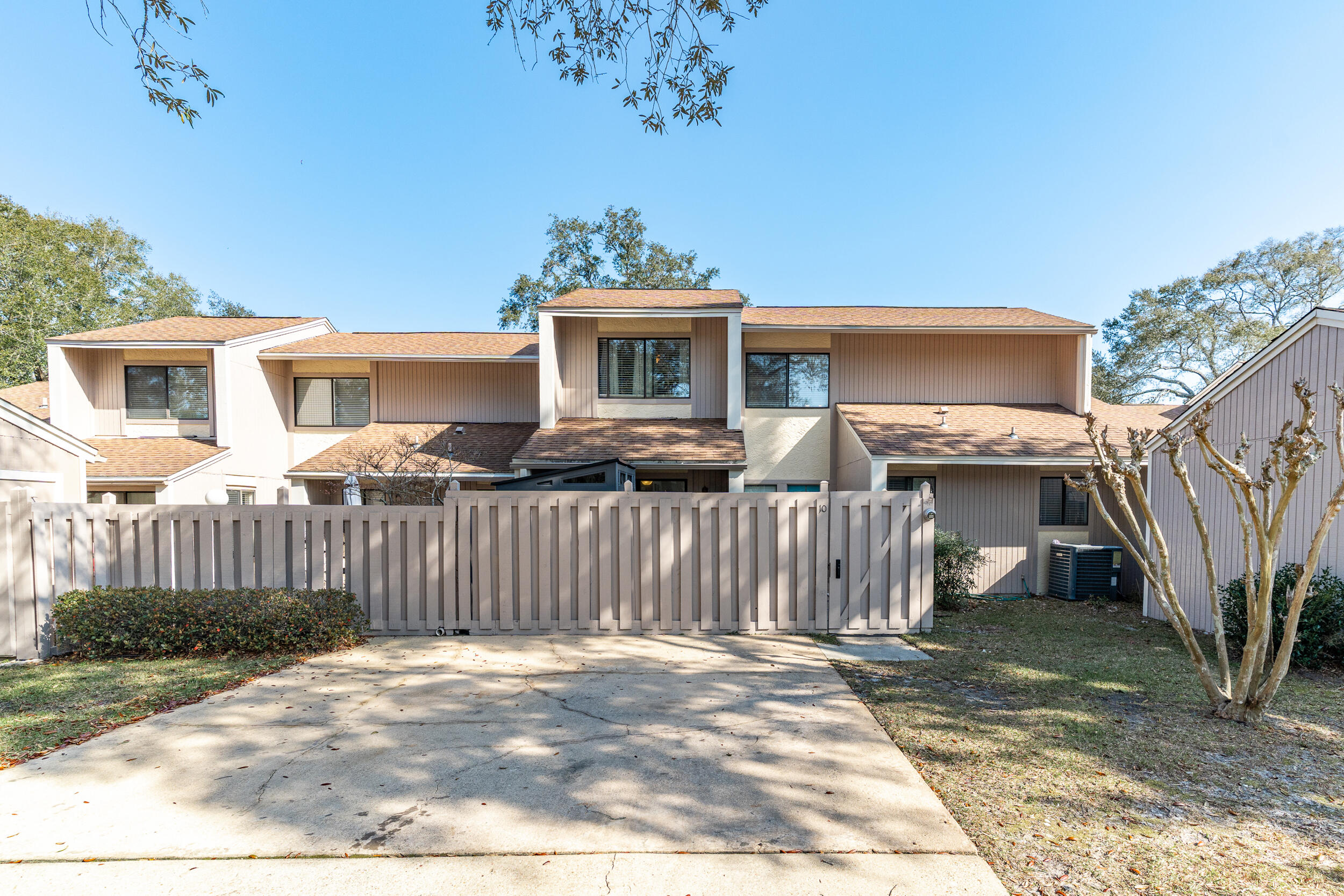 You'll love this spacious, tastefully updated Bluewater Bay townhome. A private gate leads to the front door, opening to a tall, bright foyer. The floor plan splits: one hallway leads to the living room awash with light, adjacent to the colorful, versatile dining area. Sliding glass doors off the dining area lead to the back patio and yard. The roomy kitchen has space for your gadgets and features a pass-thru breakfast bar. The other side of the hall hides a half bath, laundry room and door to your sunny primary bedroom. Your bedroom has its own private patio! The updated en suite features a spa-like shower. There's an extra room off the kitchen that can be an office, formal dining or sitting room. Upstairs, find two generously sized bedrooms and full guest bath. Live the Bluewater life!