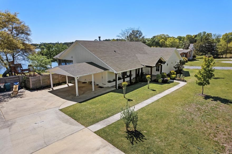 Welcome to your luxurious lakefront oasis! Originally built in 1956, this home underwent a complete remodel in 2020, seamlessly blending vintage charm with modern elegance. During the remodel process every detail of this residence was meticulously thought out and crafted with durability in mind, from the complete re-wire and re-plumbing with PEX to the new truss system and 15/16 plywood sheathing even on the roof deck. As you step inside, you'll be greeted by breathtaking views of Lake Stanley from nearly every room. The expansive living space features an impressive 26' wall of windows, offering panoramic vistas of the serene lake. The open concept floor plan seamlessly integrates the kitchen, dining room, and living room, creating an ideal space for entertaining or relaxing with loved