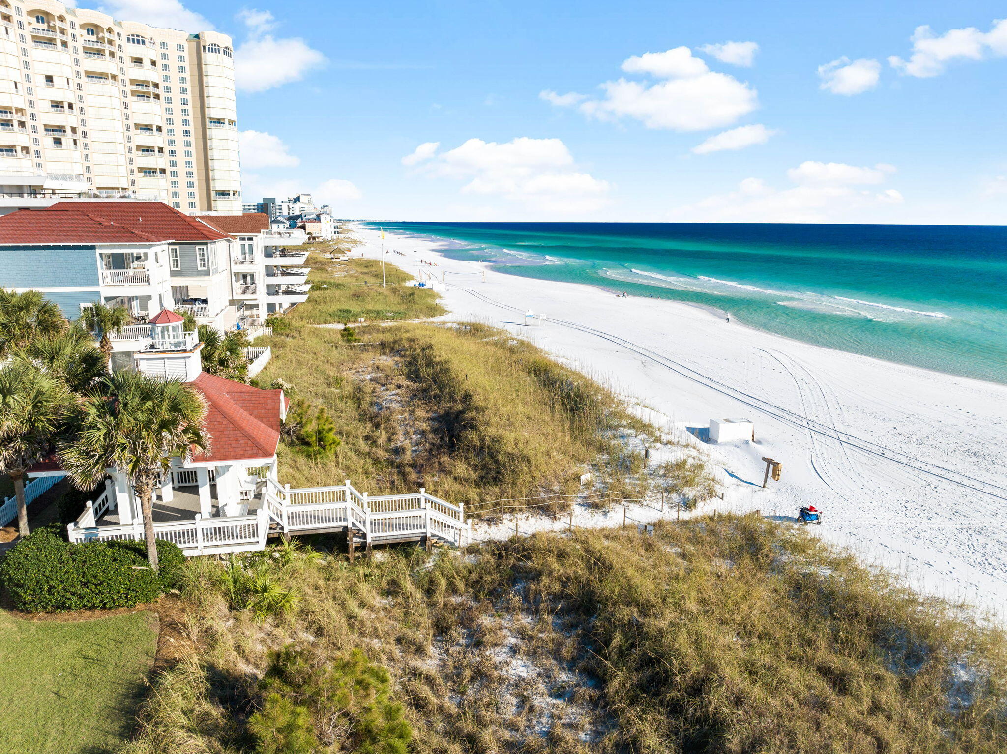 Step out your front door and find yourself mere steps from one of the most beautiful beach accesses in the area, located within the prestigious gated community of Shipwatch. This comfortable and inviting three-bedroom, three-bathroom two-story home seamlessly blends coastal charm and modern convenience, offering an exceptional haven for beach lovers. The main house features an open floor plan designed for effortless entertaining, with a ground-floor bedroom and an oversized master suite upstairs. French doors open to a private pool area, perfectly positioned between the main residence and the charming carriage house. The carriage house boasts a living area, kitchenette, balcony, two bunks, a king bed, and additional sleeping nooks, making it an inviting retreat for guests or family. Sold fully furnished, this property is ready for immediate enjoyment or rental potential. A spacious two-car garage provides ample storage for a golf cart, beach gear and more. With its unbeatable location, stylish design and thoughtful amenities, this home offers the ultimate beachside lifestyle.