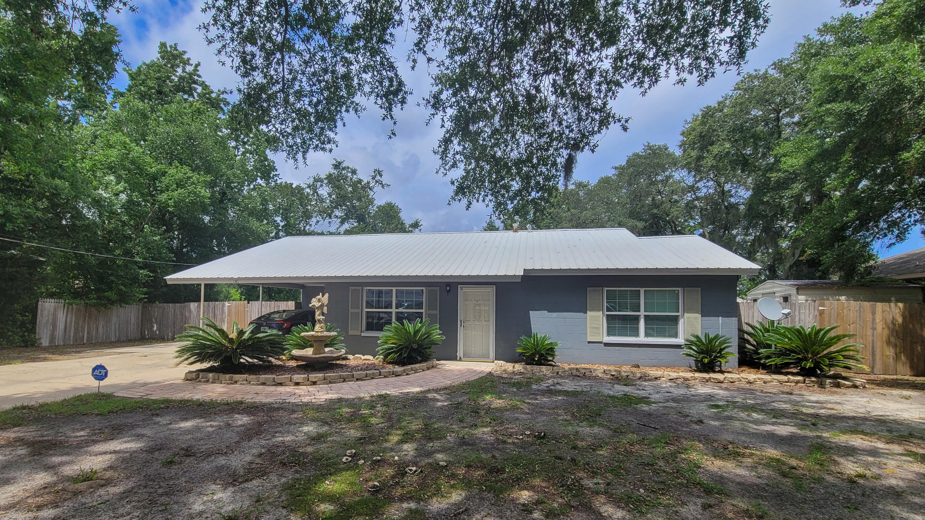 FANTASTIC HOME situated on a large lot in the center of Fort Walton Beach. Uniquely updated floor plan with special features throughout. Spacious living area with plank laminate flooring and two large windows for natural light. Dining area has shiplap walls, built-in shelves for decorative pieces and opens into the living area for easy entertaining. Light and bright kitchen with lots of cabinets, counterspace, backsplash, stainless/black appliances and tile flooring. Breakfast area has a door that leads out to the large covered patio perfect for cookouts this summer. You will love this outdoor space with a firepit area, two storage buildings, fully fenced yard and plenty of pool for a future pool. Master bedroom and bath has its own wing complete with a walk-in closet. See More...