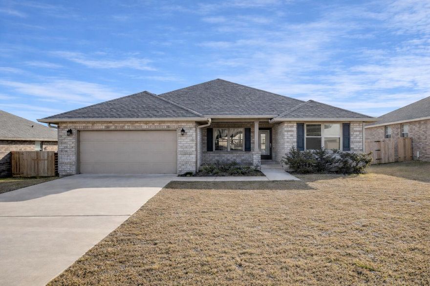 This nearly new, one-year-old home offers 4 bedrooms and 3 full bathrooms with a smart split-bedroom layout designed for comfort and privacy. The kitchen features white lace quartz countertops, gray Cape Cod-style cabinetry, stainless steel appliances, and a walk-in pantry just off the kitchen. Luxury vinyl plank flooring runs through the main living areas, with carpeted bedrooms for added comfort. Coordinated cabinetry and countertops in the bathrooms create a cohesive, modern look. The open-concept family room flows into the kitchen and breakfast nook, ideal for everyday living and entertaining. A separate formal dining room adds flexibility for hosting or a home office. Recent upgrades include new gutters, a privacy fence, and custom blinds, making this home truly move-in ready.