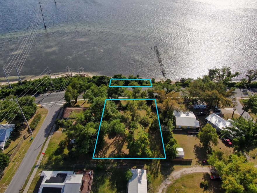 Bay Front lot in Parker, high and dry and over 3/4 an acre with stunning views looking Westward towards Tyndall. Watch sunsets daily from your front porch or dock. Opportunity to build a dock out to deep water, while your home sits high and dry above the Bay. The lot is located in the CRA of Parker and can possibly be split up into 2 lots, buyer to verify.