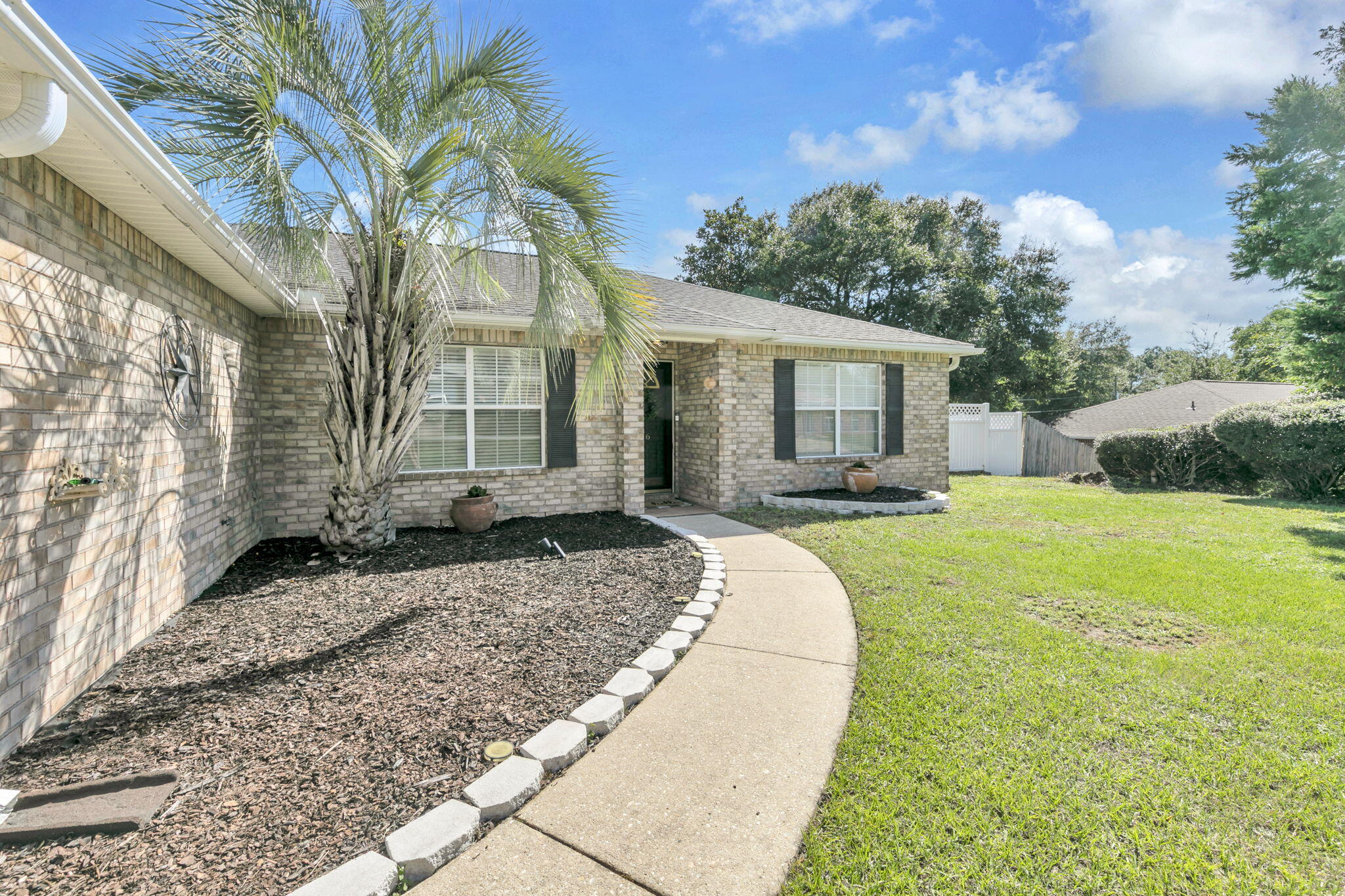 4 bedroom all brick home on the South end of Crestview! Updated flooring in living room and primary, brand new carpet in guest bedrooms. Large walk-in closet in primary and double vanity, tub/shower combo and separate water closet. Kitchen is spacious with plenty of countertop space and an island. Eat-in Kitchen offers plenty of space for a large dining room. Off of the living room is an enclosed, tiled patio. Pavered seating area in the backyard with storage shed. Plenty of flat yard space enclosed with a white vinyl privacy fence. Garden beds have been freshly mulched, new sod in the backyard. This home is ready for its new owners!Transferrable termite bond.Roof is 2017, HVAC is 2021, water heater 2011.