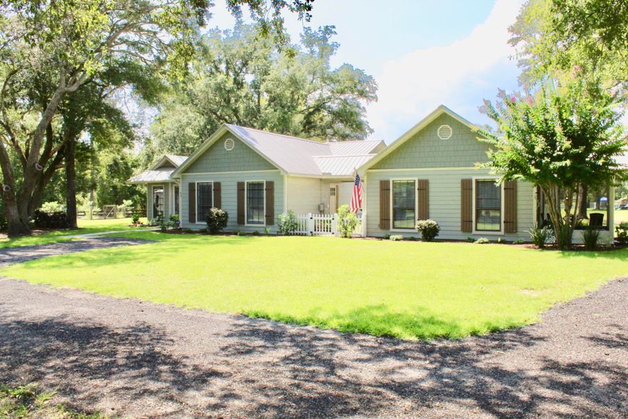 No HOA!  The main house has about 1430 sqf (feels much larger) with 4 bedrooms and 2 baths, family room with a wood burning fireplace, tongue and groove ceiling with beams, wood look flooring through out.  Granite counter tops, oversize laundry room and mud room entry thru courtyard. Separate guest house has 774 sqft and includes master with  laundry hook up, full size bath with walk in shower and kitchen family room combo. Both homes are truly breathtaking. This property is on over 1 acre, beautifully maintained. The Storage Shed is 24X30 and is heated and cooled, currently being used as workshop. The guest house has a covered walk way to the main house with concrete slab and lights, metal roof was installed in 2018, 2015 new AC and hot water heater. 3/car carport and a covered shed.