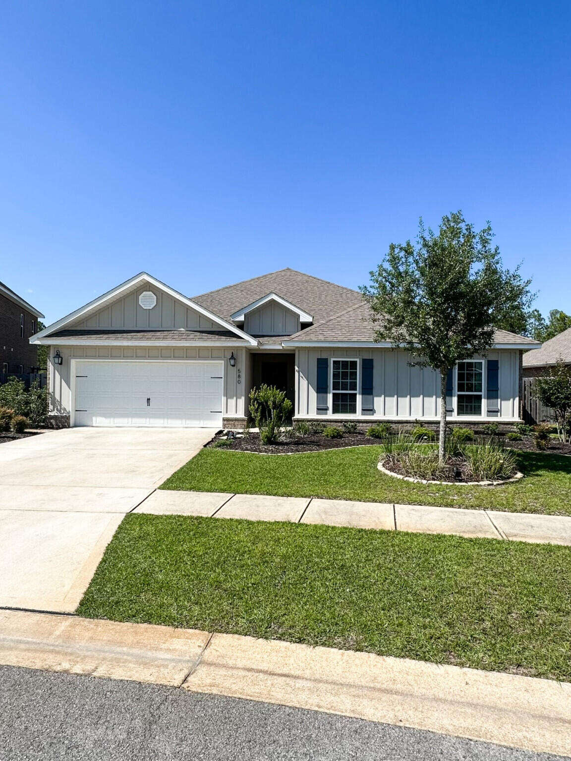 Discover your dream home at 580 Cornelia Street in Freeport, FL. This 2,318 sq. ft. Craftsman-style residence with upgraded coastal-colored LVT flooring and granite countertops is located on a fenced premium lot features 4 bedrooms, 2.5 baths, and an open-concept living, kitchen and dining area creating a very spacious feeling. The living area with additional area for family gaming enhances the living space. The spacious kitchen with Island overlooking the living area and dining, is perfect for entertaining or gathering with family and friends. The kitchen is a culinary delight for those who love to cook and entertain as it boasts stainless steel appliances, including a five-burner gas stove/range, dishwasher, microwave, and walk-in pantry.