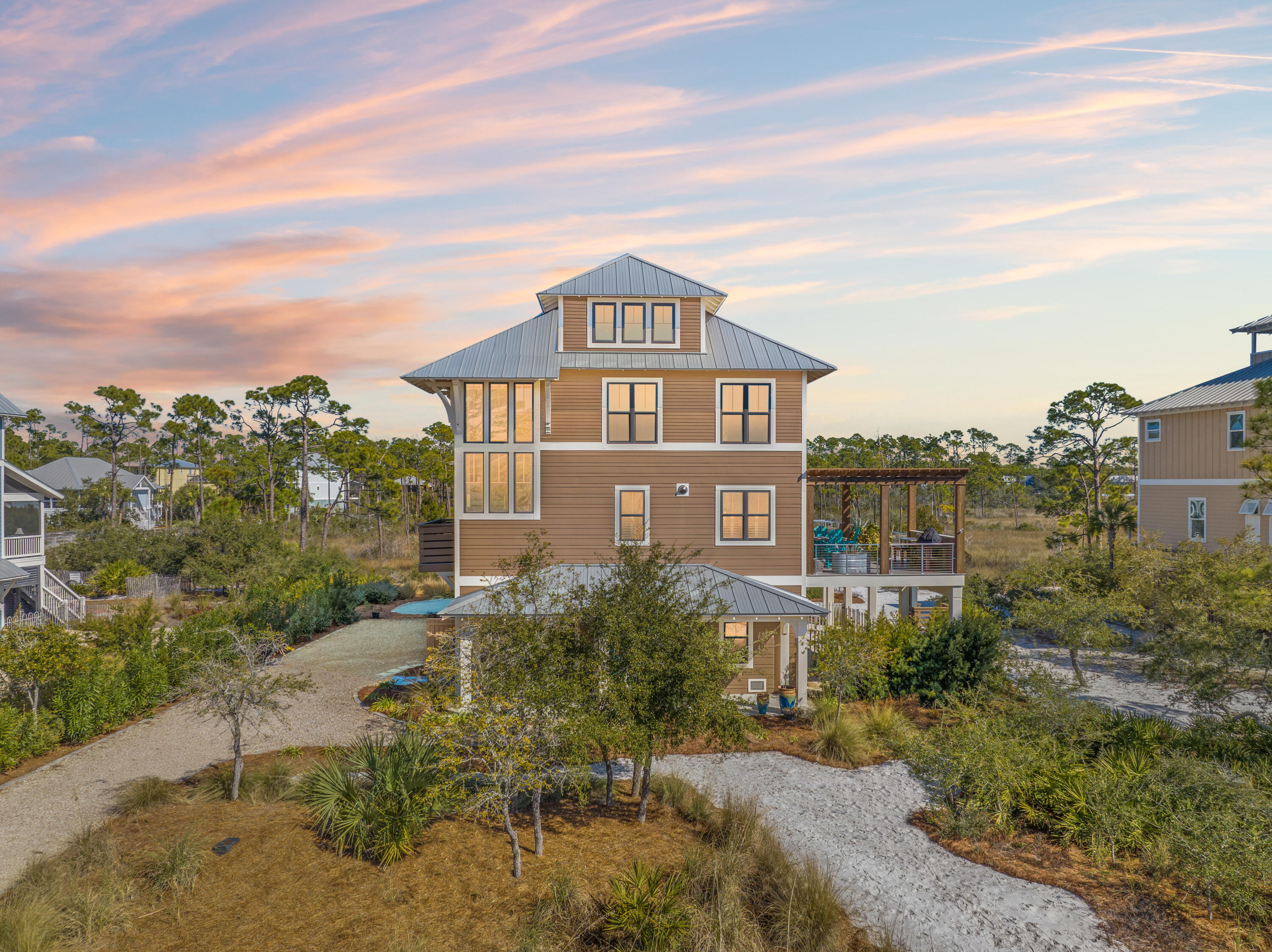 Welcome to 510 WindMark Way, a coastal luxurious 4-bed, 4-bath custom home built in 2021, offering 3,563 sqft of climate-controlled living space. Designed for comfort and elegance, it features high-end finishes, custom panel walls, and ceramic, stone, and wood flooring. The gourmet kitchen includes BlueStar appliances and stunning St. Joseph Bay views. The master suite offers a spa-inspired ensuite and direct patio access. Outdoors, enjoy 1,480 sqft of covered porches, a balcony kitchen with pergola and outdoor kitchen, and the best panoramic views. Residents have access to exclusive amenities, including 3 pools, a private clubhouse, bike paths, and more. Built for efficiency and security with hurricane-rated windows and more.