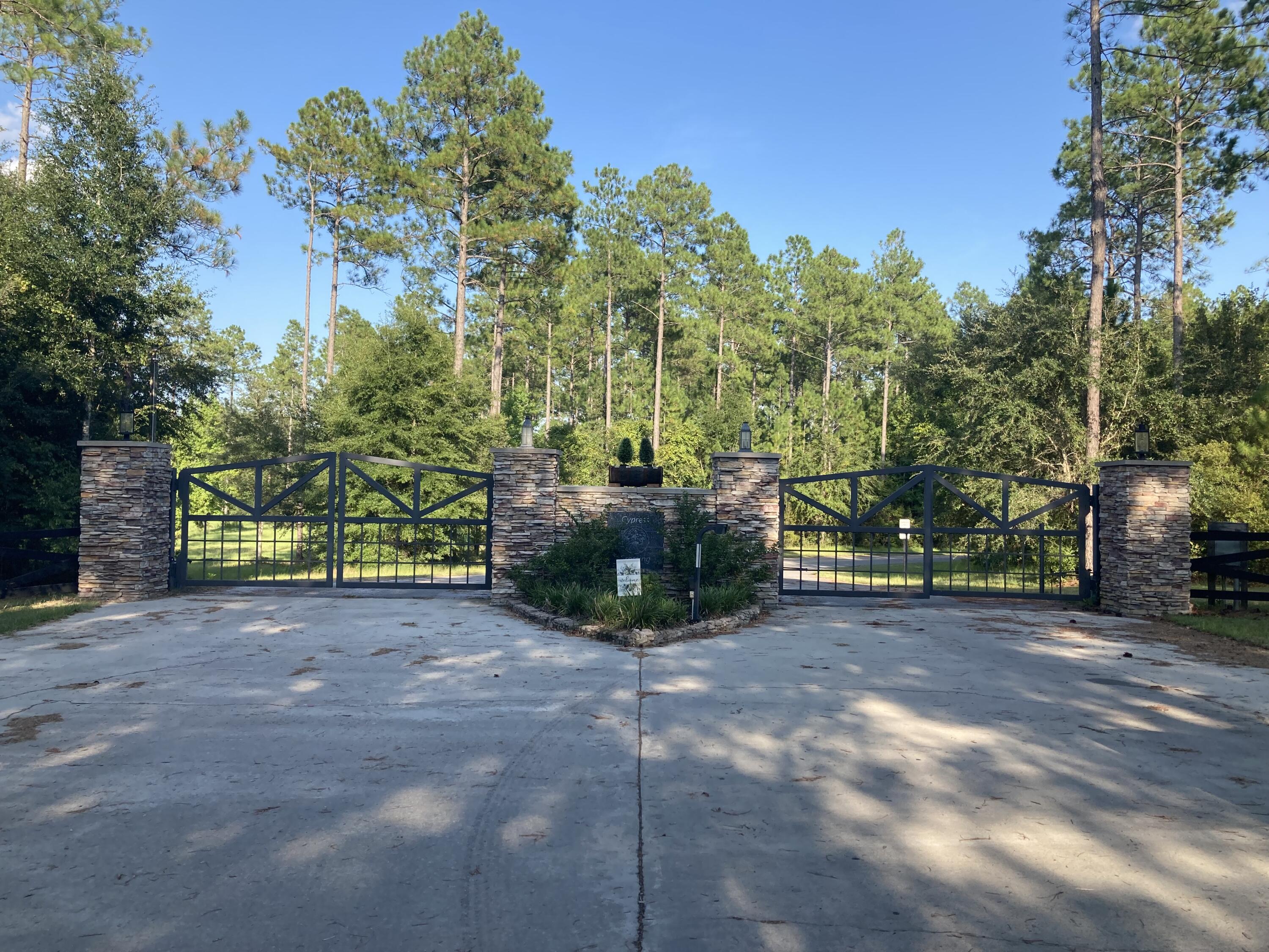 Discover the allure of this stunning 13.51-acre property nestled within the Cypress Crossing gated community! Unleash your imagination as you explore the boundless possibilities that this property has to offer. Whether you envision constructing your dream home or crafting a tranquil vacation retreat, this canvas is ready for your creative touch. Located on a paved road with underground power. Don't miss the chance to make this gem yours - where the perfect blend of nature and luxury awaits!